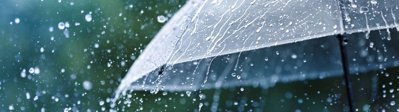 An umbrella open in the rain
